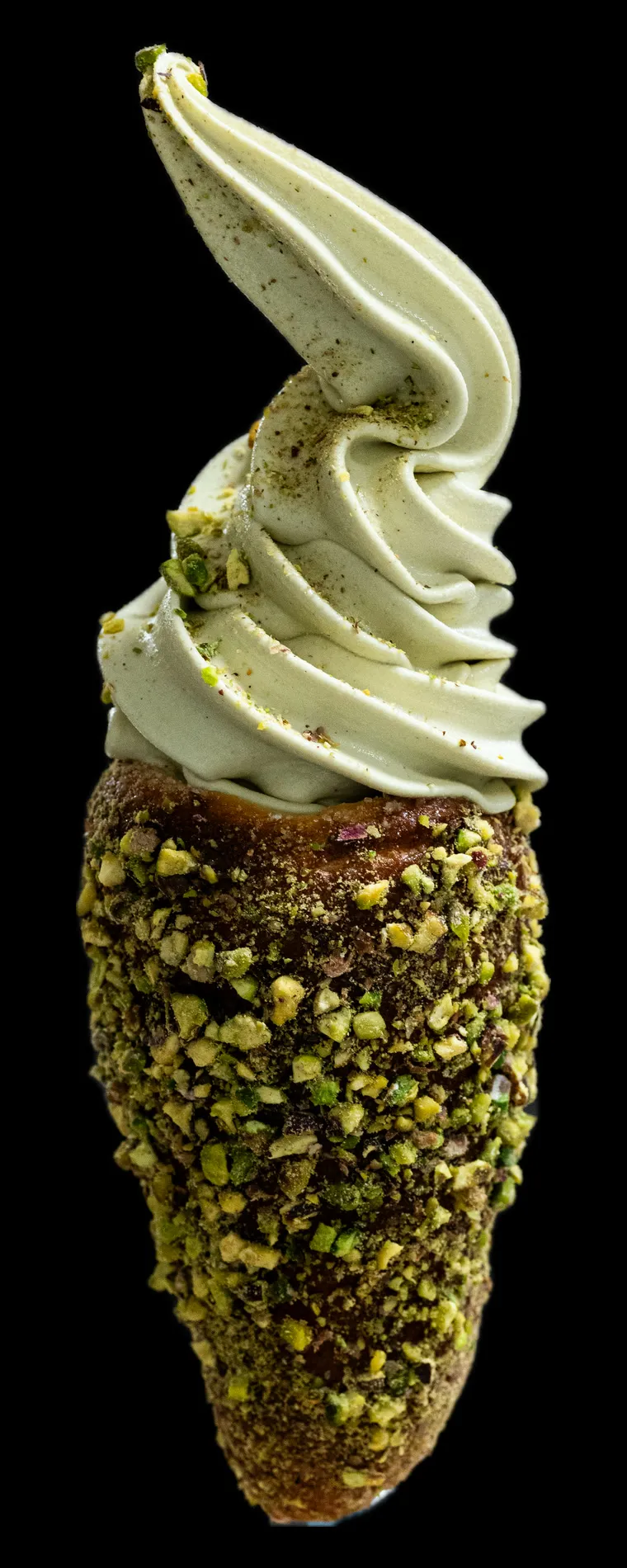 A chimney cone in crushed pistachio, filled with pistachio gelato