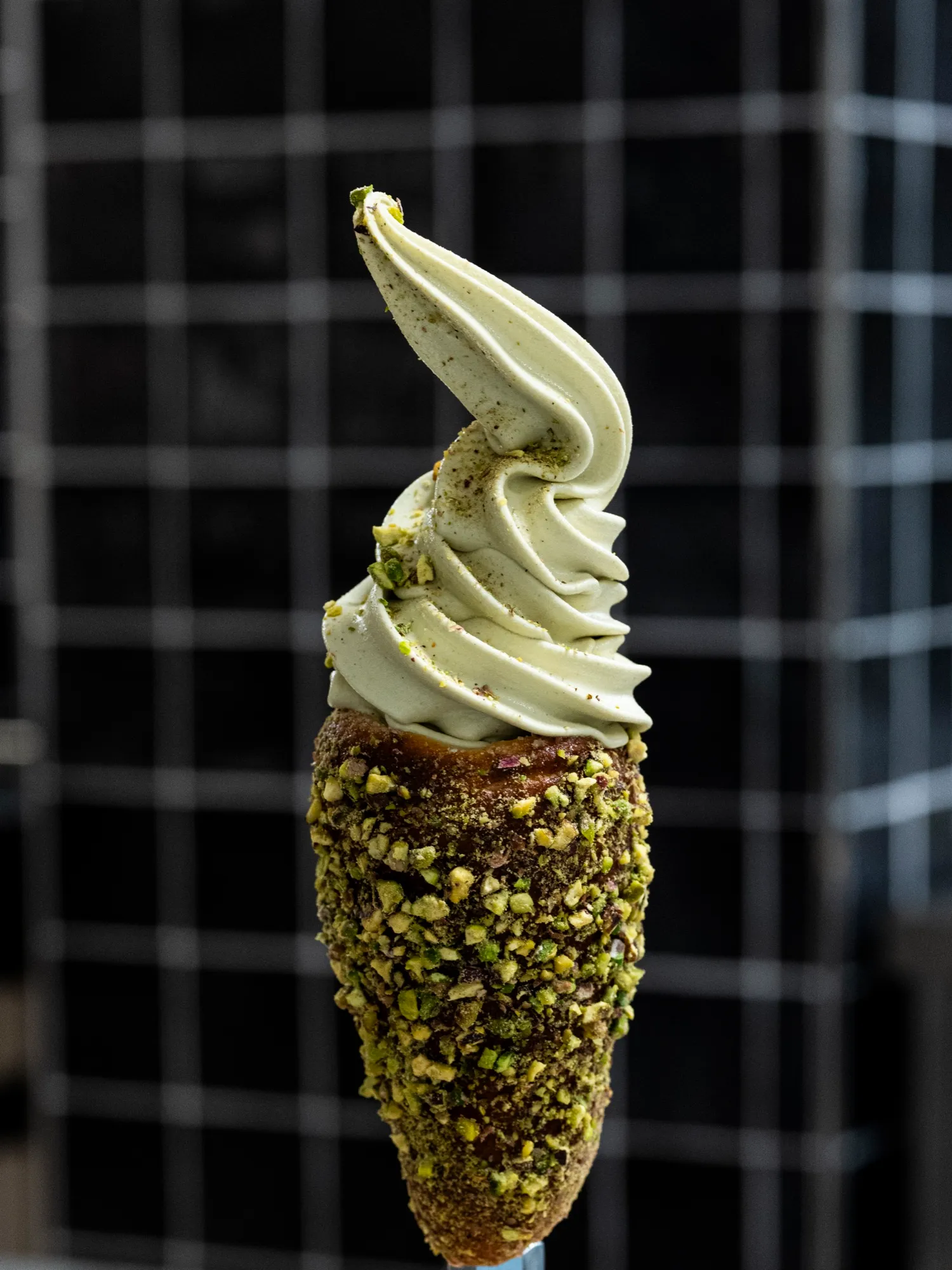 A pistachio-crusted chimney cone with pistachio gelato
