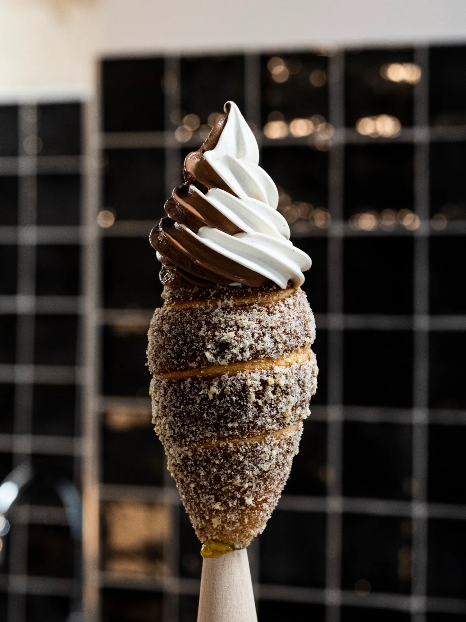 A chimney cone with a twisted swirl of vanilla and chocolate gelato